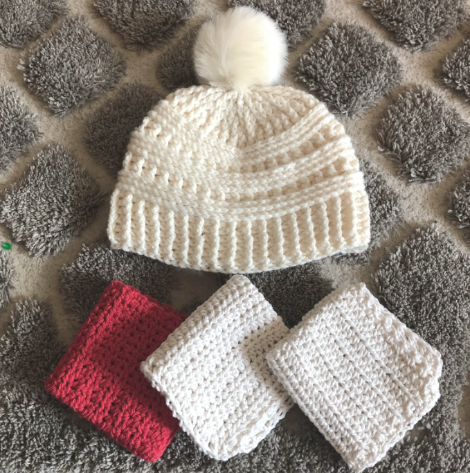 crochet white hat and three pieces of red and white crocheted cloth