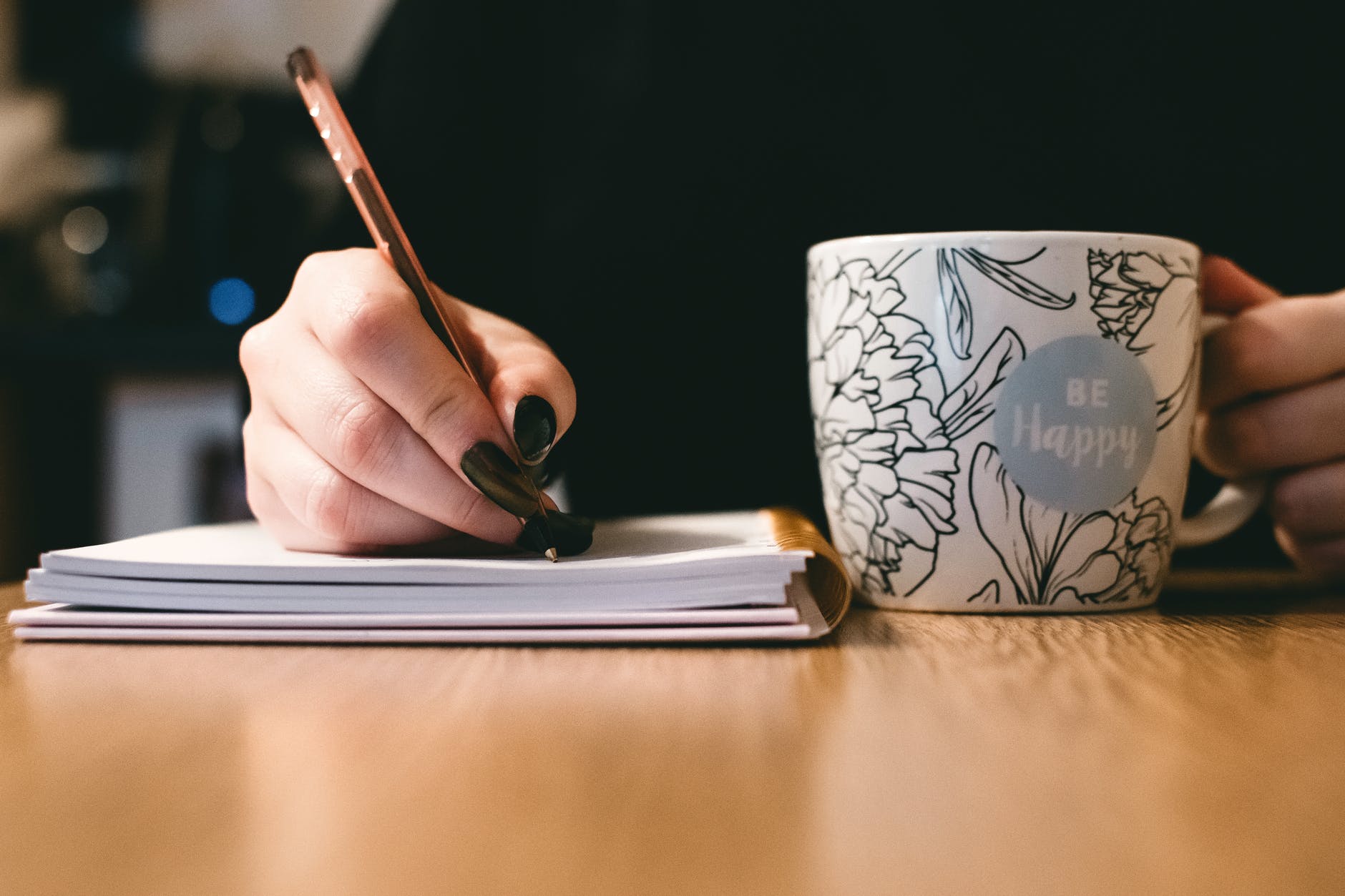 person holding white ceramci be happy painted mug; poetry;
C. L. Schneider Author Spotlight