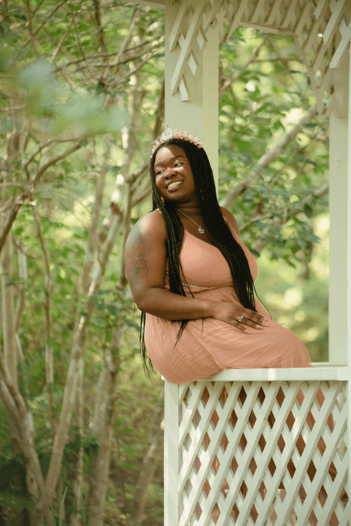 Winnifred Tataw fairy pink sitting on white porch 