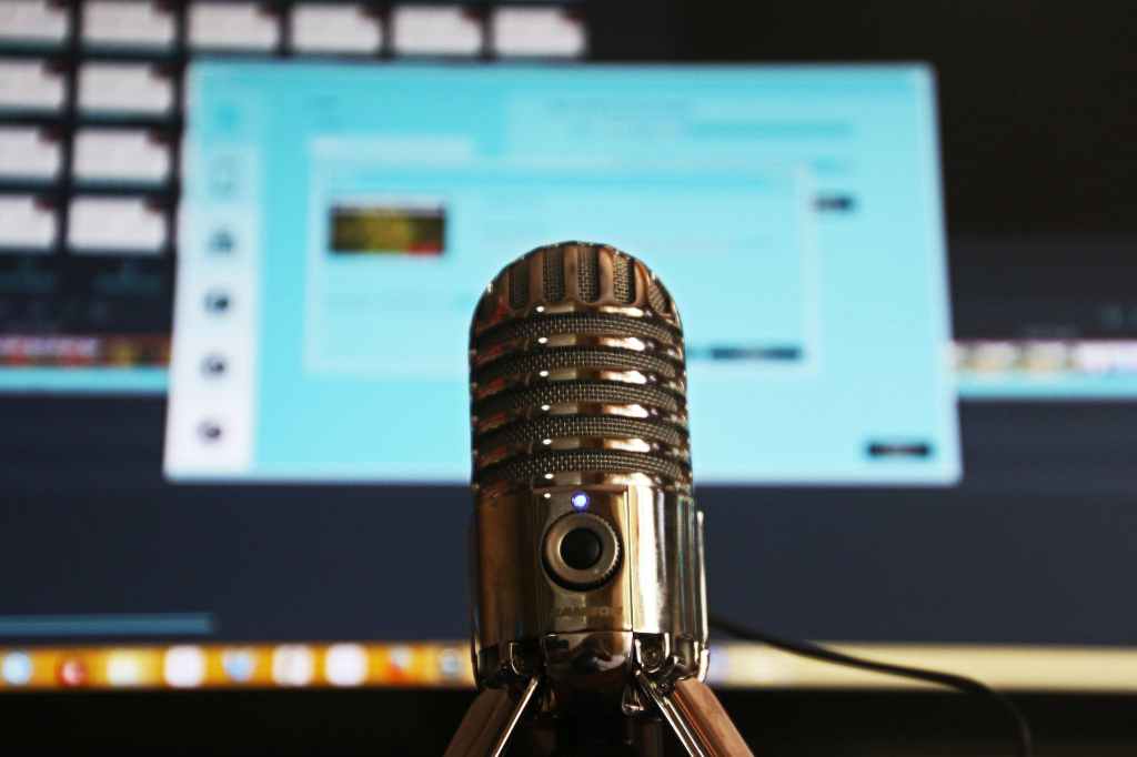 Gray stainless steel condenser microphone in a recording studio