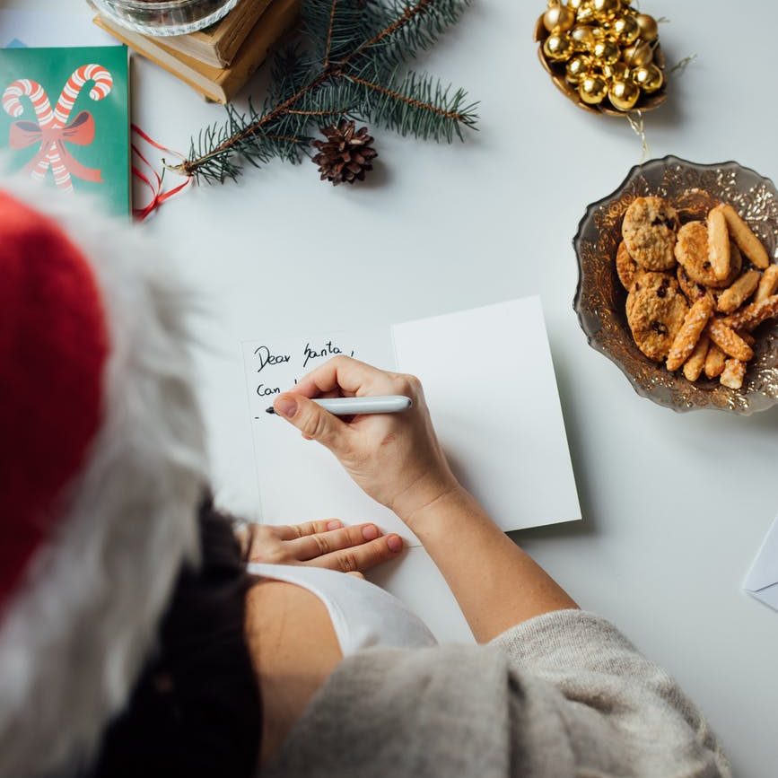 person holding writing on a paper
