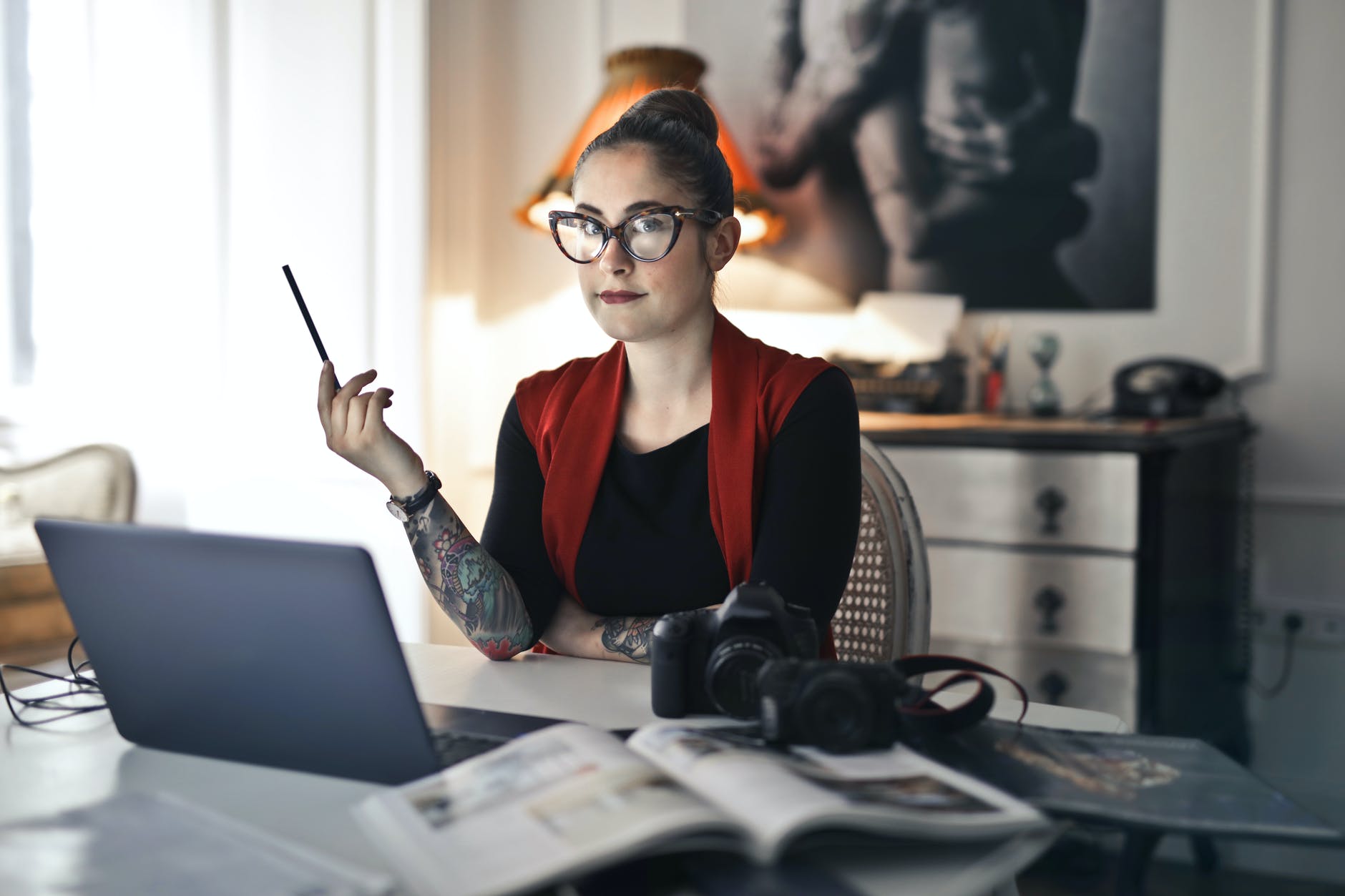 informal adult woman using laptop for working with photo project; editor; editing