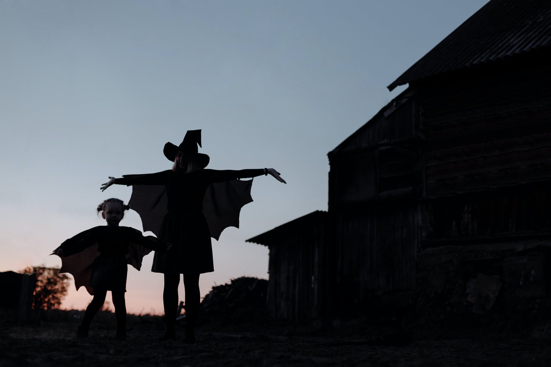 silhouette of witch mom and daughter