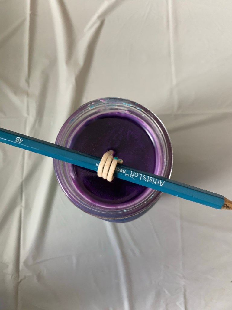 DIY candles on Win's Books; Let your candle settle and cool for 4-6 hours! Use the pencil to keep the candle wick in place.