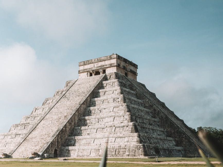 gray pyramid on grass field during day