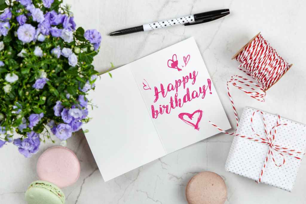 happy birthday card beside flower thread box and macaroons; birthday book sale on Win's Books LLC