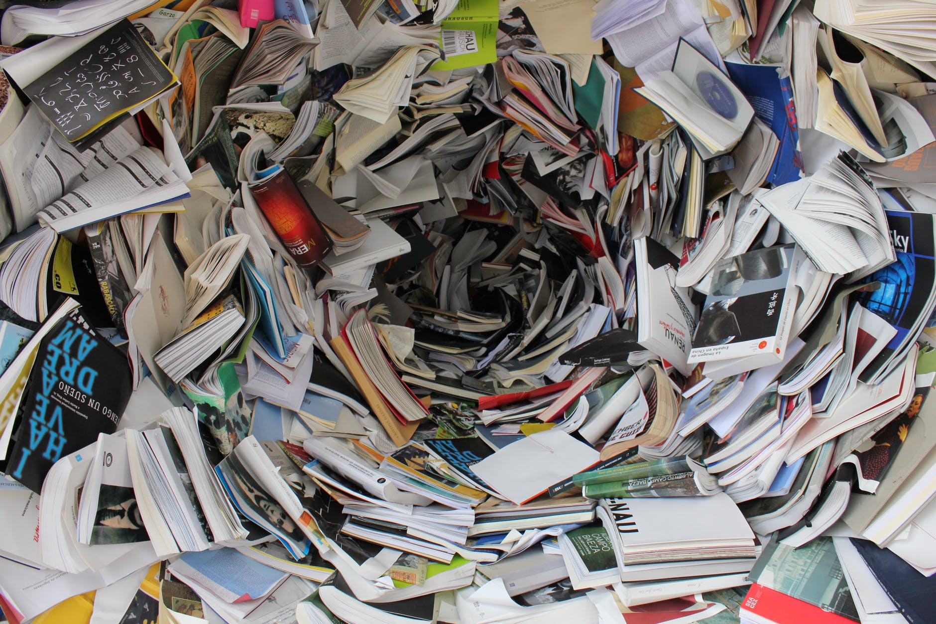 pile of covered books; Research, research, research; 8 Tips About World Building New Writers Should Know