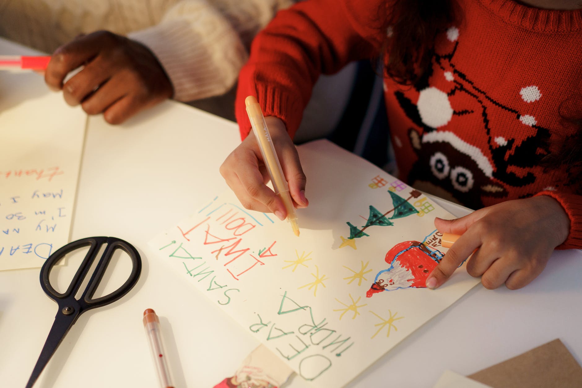 a person in red sweater making a christmas letter