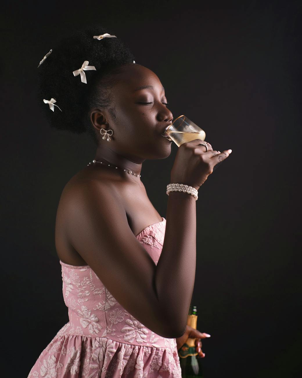 elegant woman sipping champagne in studio setting