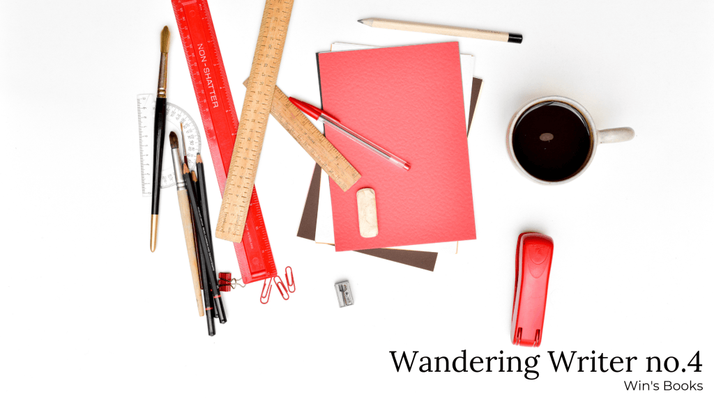 white table with red office supplies and coffee on it