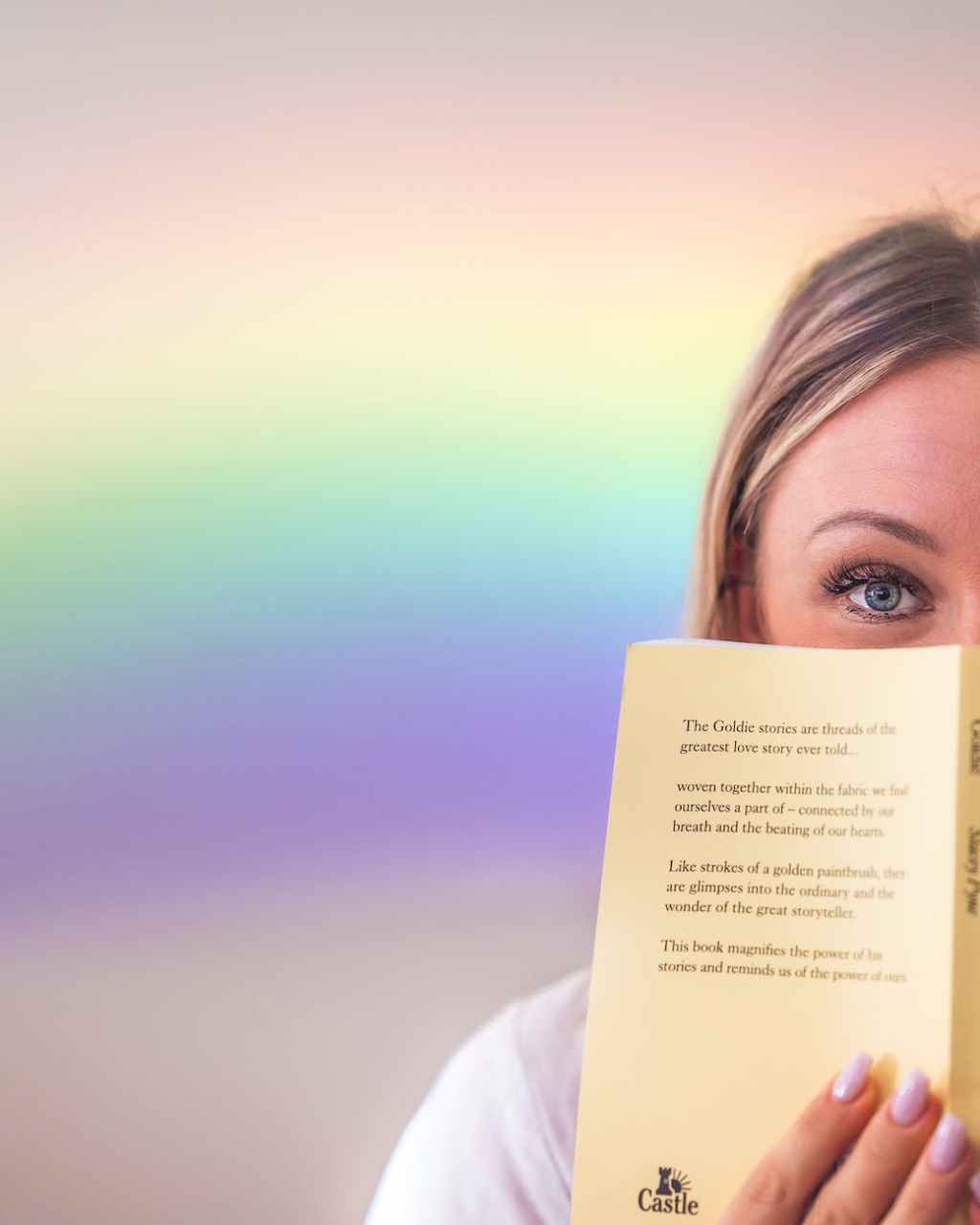 cheerful woman covering face with book