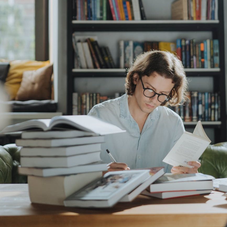 man in white dress shirt reading book; beta reader