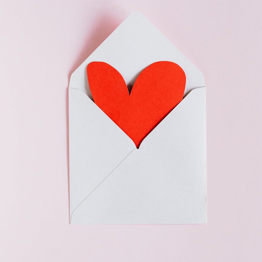 white envelope with red paper heart; amour books
