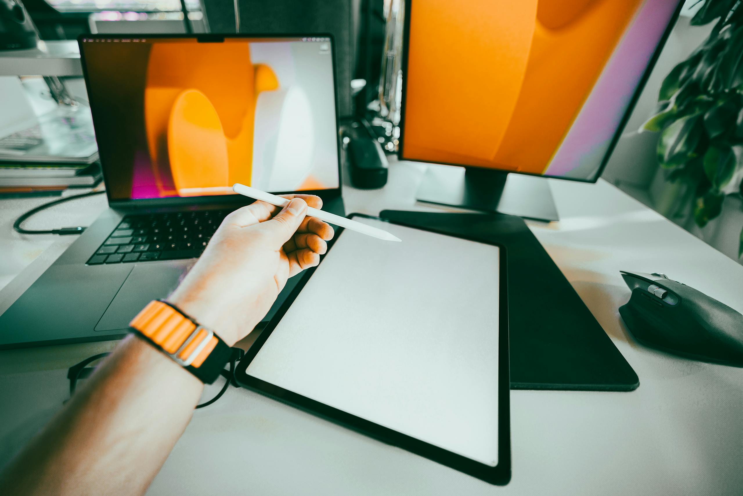 Meeting notes hand holding digital tablet stylus. Graphic tablet empty screen mockup. Office space interior.