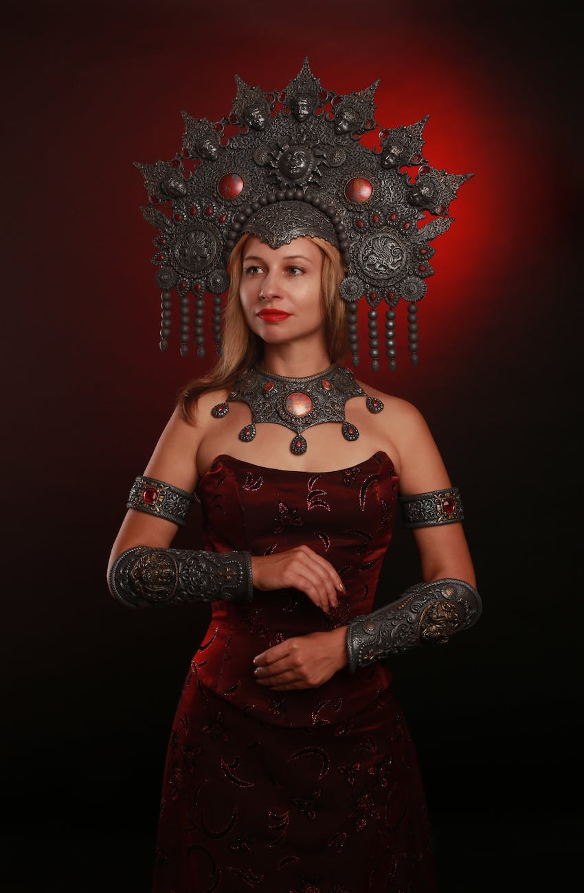 woman in red dress wearing ornate iron halo crown