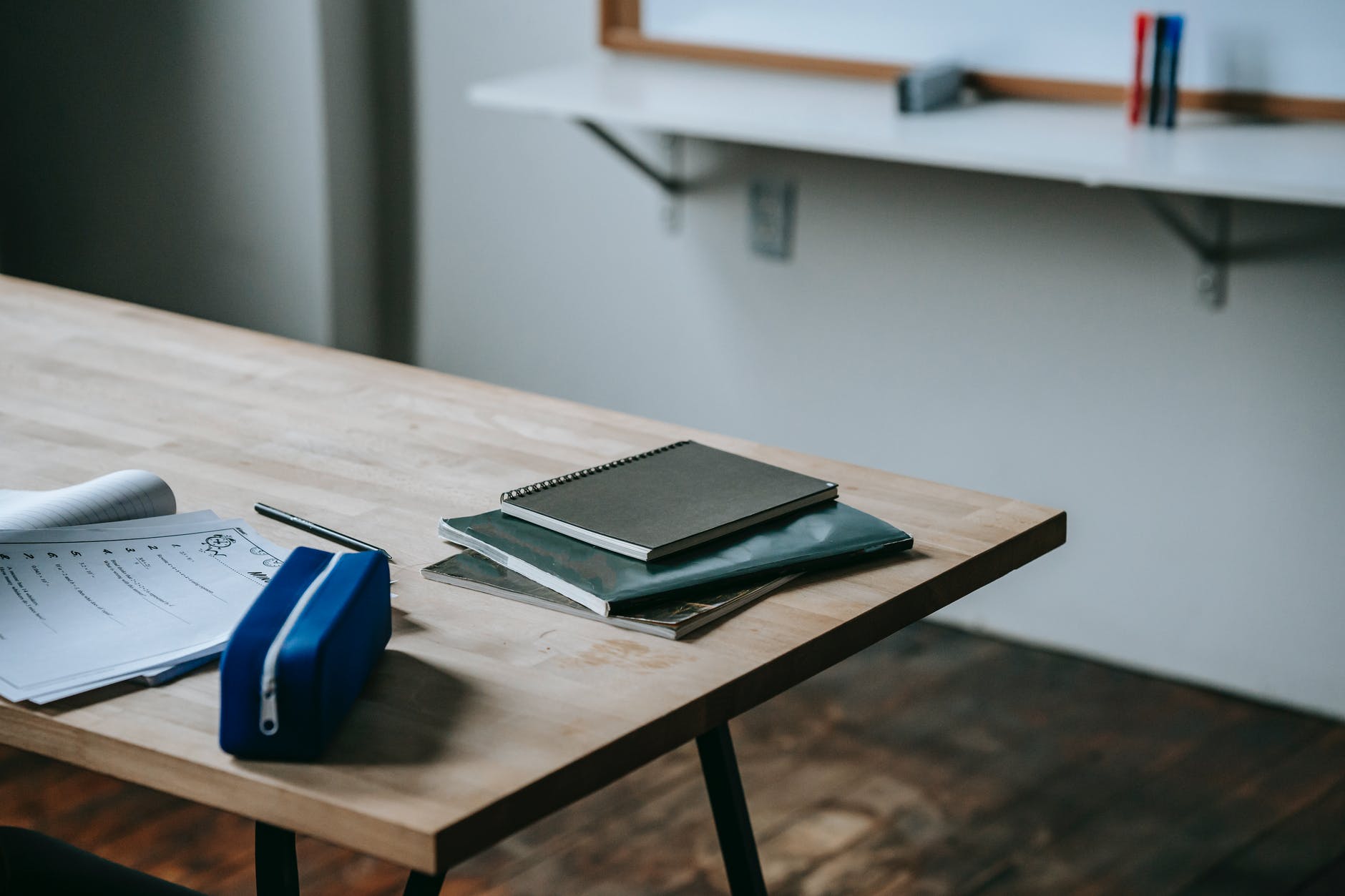 student desk with copybooks and pencil case; Author Letrise T. Carter