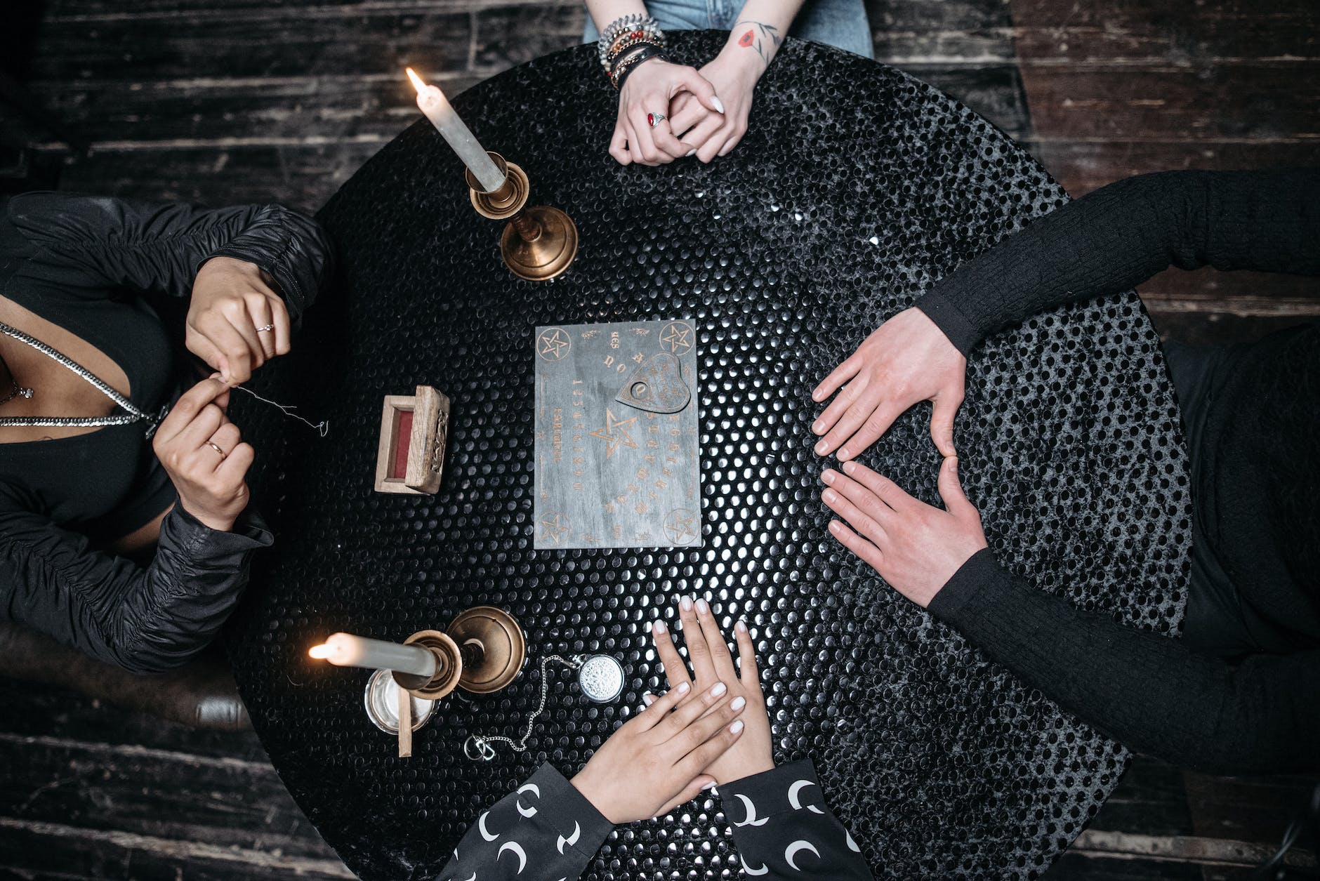 people sitting at the round table with wooden board
