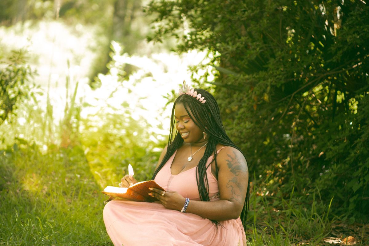Winnifred Tataw pink fairy smiling and writing and reading